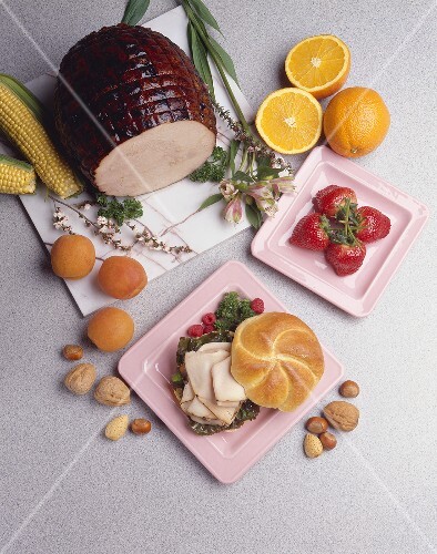 Turkey Sandwich on a Roll; Turkey on a Cutting Board; Strawberries
