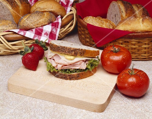 Ham and Swiss with Mustard on Rye Bread on a Small Cutting Board