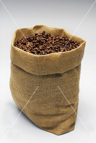 A jute sack full of roasted coffee beans
