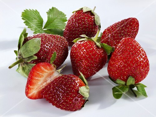 Fresh strawberries, one halved