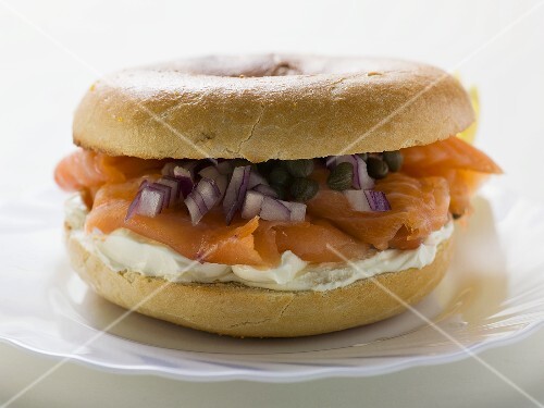 Salmon, cream cheese, onions and capers in a bagel