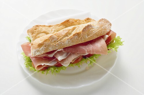 Sub sandwich with raw ham on a plate