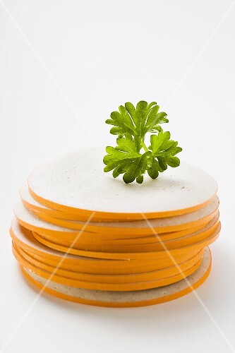Slices of Gelbwurst (pork & veal sausage) in a pile with parsley