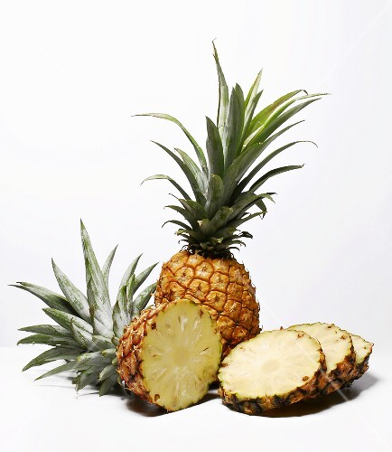 Whole and sliced pineapples