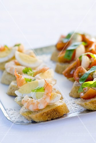 Canapés with prawn, egg, tomato, mozzarella on tray