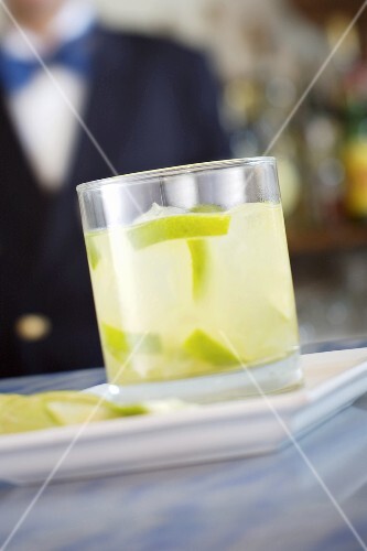 A glass of lime drink with ice cubes
