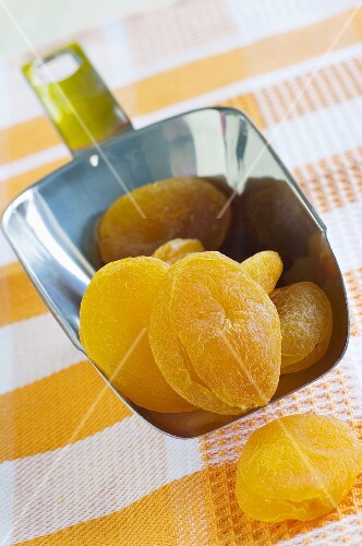 Dried apricots in a scoop