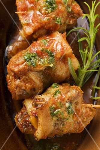 Three belly pork rolls with tomato pesto and herb oil