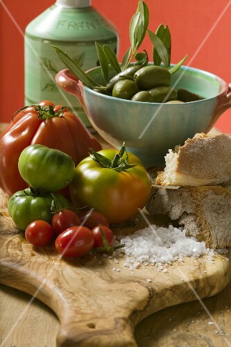 Fresh tomatoes, olives, bread, salt and olive oil