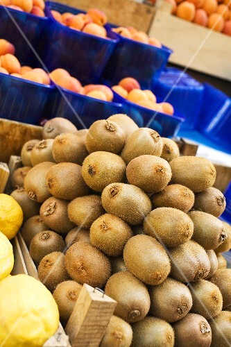 Kiwi fruits, lemons and apricots at a market