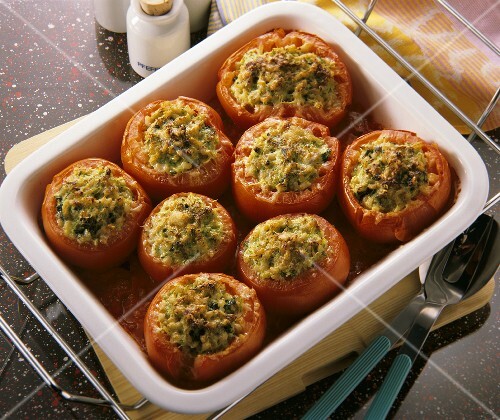Several stuffed beefsteak tomatoes au gratin