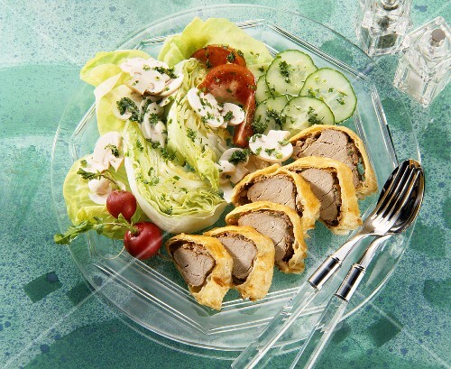 Sliced pork Wellington with raw vegetable salad