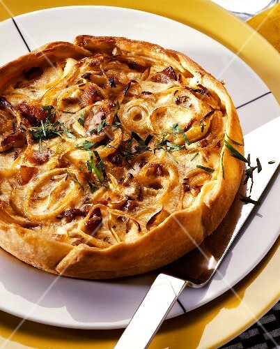 Round onion and bacon quiche in short pastry case