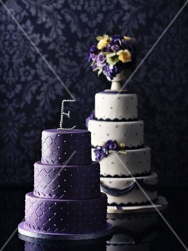 Two wedding cakes in purple and white