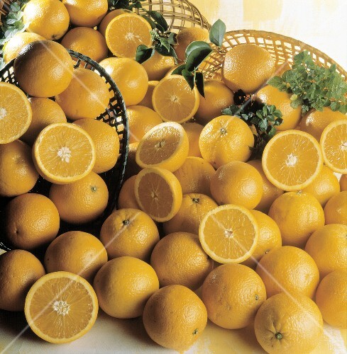 Several Oranges Spilling Out of Baskets