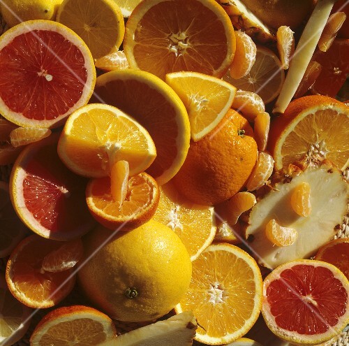 Various citrus fruits, cut in half and in pieces