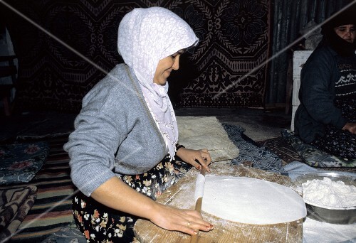 Woman Rolling Out Bread Dough