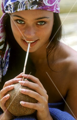 A Woman Drinking from a Coconut