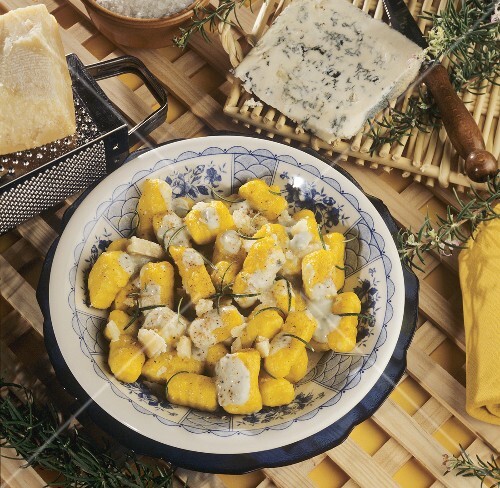 Saffron gnocchi with gorgonzola sauce in deep plate