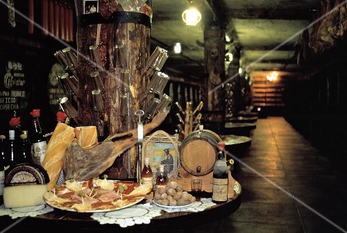 Cheese and Wine Set Up on a Table in a Wine Cellar
