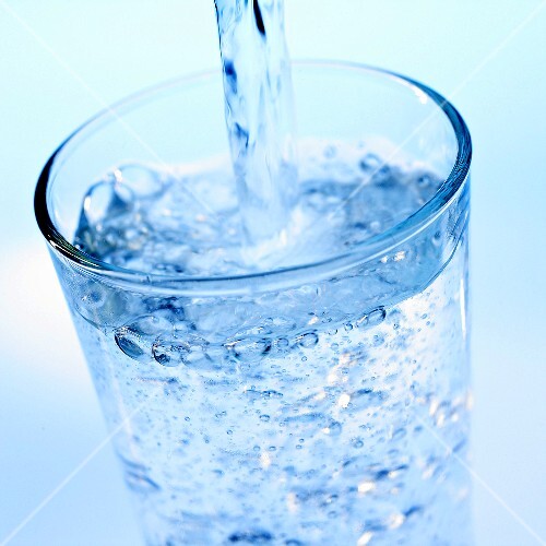 Pouring mineral water into a glass