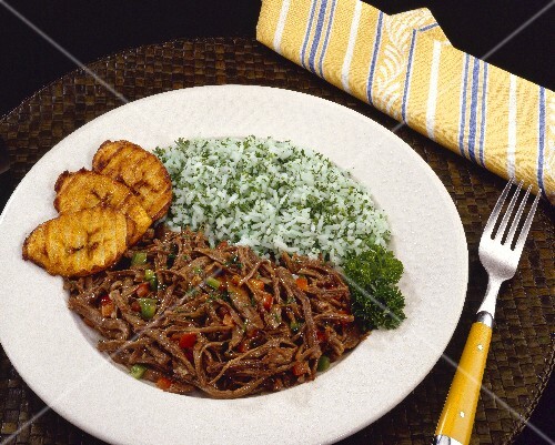 Strips of meat in tomato sauce with rice & platano, Venezuela