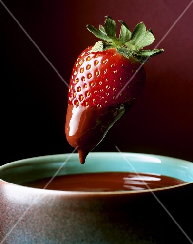 Erdbeere wird in Schokoladenfondue getaucht