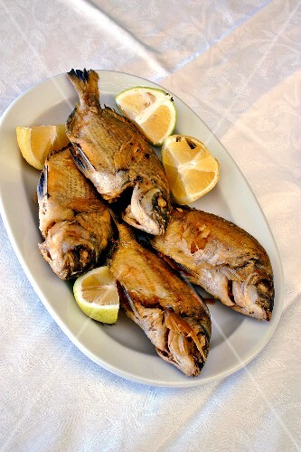 Four barbecued red mullet (sargos) on a platter (Crete)