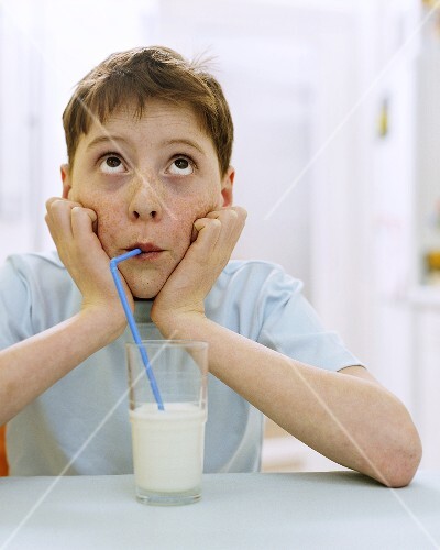 Boy drinking milk through a straw (1)