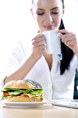 Businesswoman with a small snack (1)