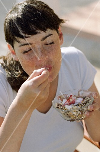Young woman eating muesli