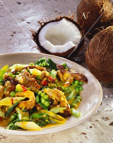 Lamb in coconut sauce with peas and spring onions