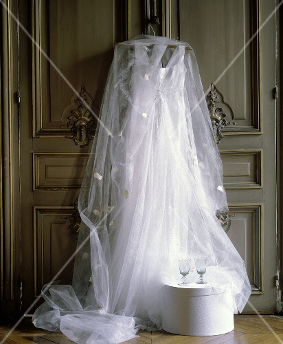 Still life with wedding dress veil and empty glasses