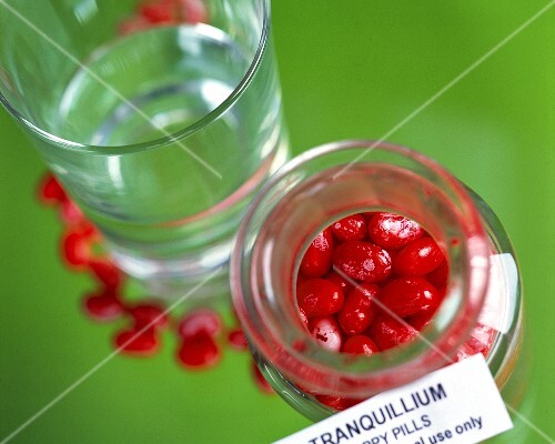 Tranquillizer pills and glass of water