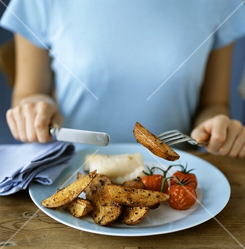 Woman eating potato wedges