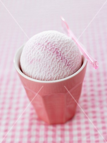 A scoop of fruit ice cream in a beaker