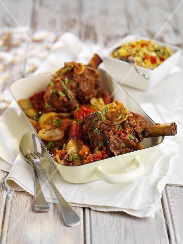 Braised legs of lamb in a roasting dish