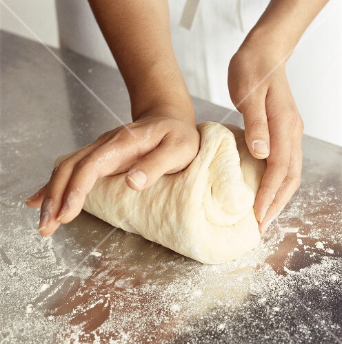 Hands kneading dough