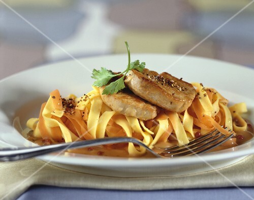 Pork fillet on ribbon pasta in pepper sauce