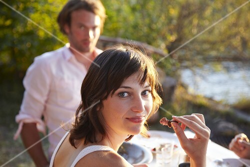Young people eating out of doors