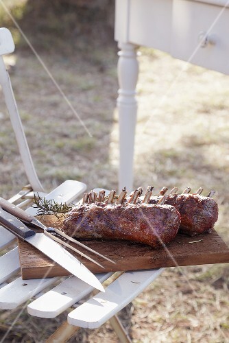 Barbecued racks of lamb with carving cutlery