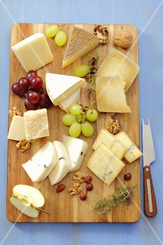 Various cheeses with grapes and nuts