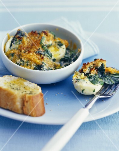 Boiled eggs baked in the oven with spinach & cheese topping