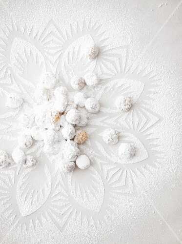 Orange marzipan balls rolled in icing sugar