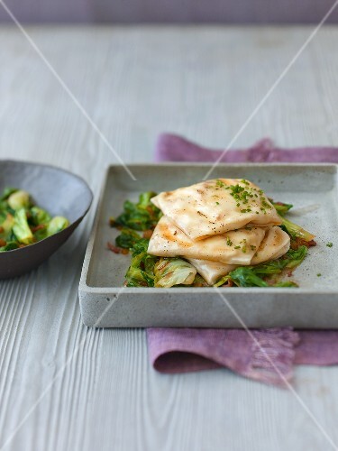 Gedämpfte Strudelpäckchen mit Schichtkäse auf gedünstetem Salat