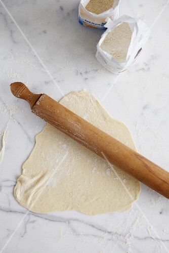 Dough with rolling pin, flour and semolina