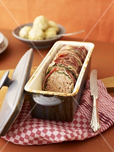 Meatloaf wrapped in savoy cabbage and bacon