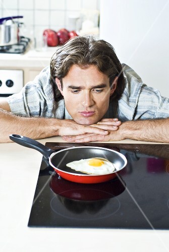 Man looking at a fried egg
