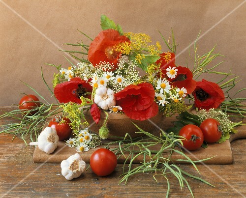 Still life with flowers, herbs and vegetables