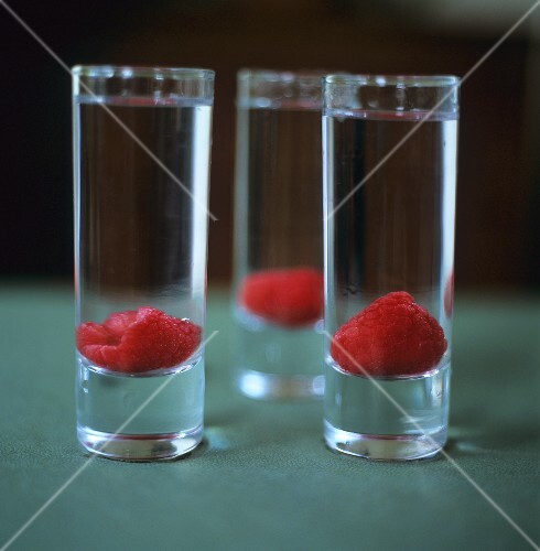 Vodka with raspberries in schnapps glasses